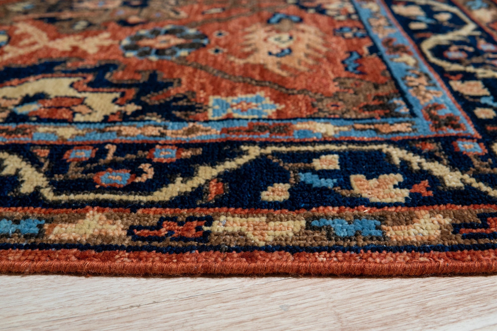 Elegant Traditional Rust Hand Knotted Wool Rug, a richly textured wool rug with intricate traditional patterns in warm rust and muted tones, displayed in a bright, modern living space.