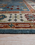 Mira Traditional Red Hand Knotted Wool Rug, richly patterned and vibrant, displayed in a modern living room setting.