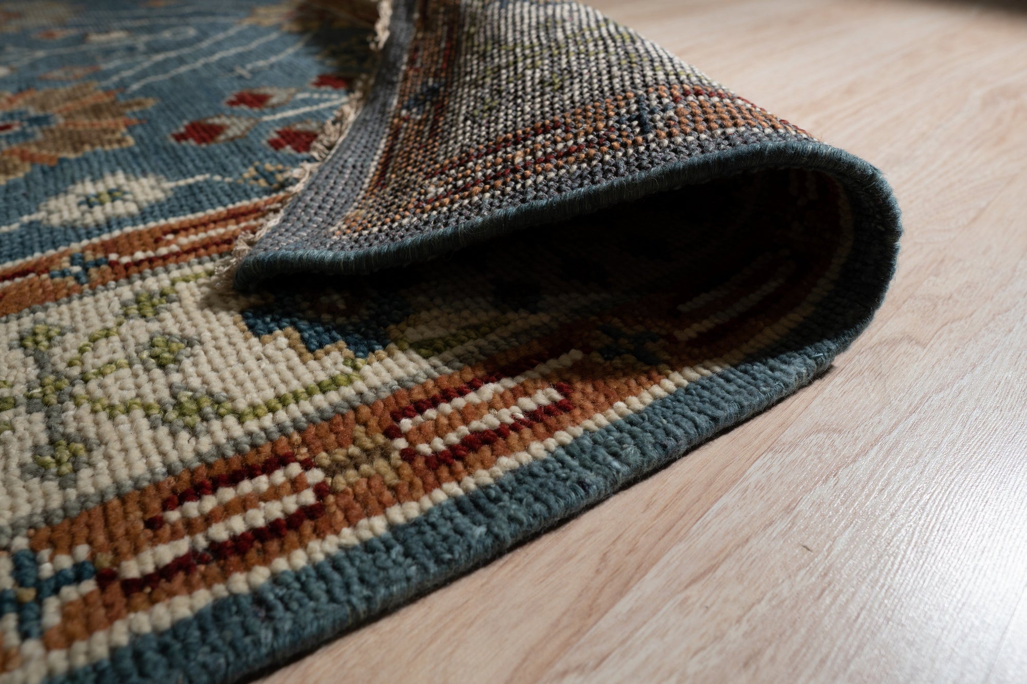 Mira Traditional Red Hand Knotted Wool Rug, its rich red tones and intricate patterns enhancing a warmly lit interior space.