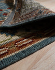 Mira Traditional Red Hand Knotted Wool Rug, its rich red tones and intricate patterns enhancing a warmly lit interior space.