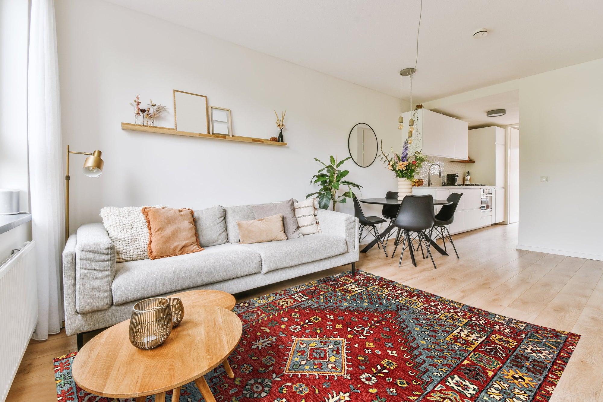Mira Traditional Red Hand Knotted Wool Rug, vibrant reds and intricate patterns flow across this hand-knotted wool rug, showcased as a warm accent in a comfortably furnished living room.