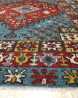 Mira Traditional Red Hand Knotted Wool Rug, vibrant crimson wool anchoring a room, hand-knotted patterns unfolding in rich detail, showcasing intricate motifs within a traditional setting.