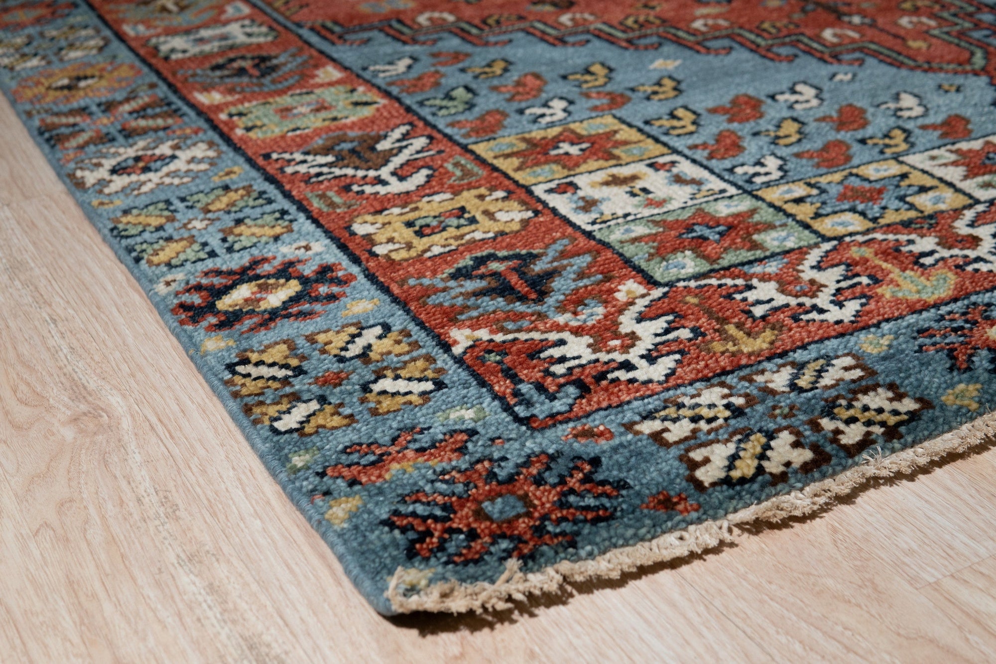 Mira Traditional Red Hand Knotted Wool Rug, a rich red wool rug hand-knotted with an intricate traditional pattern, displayed to showcase its texture and detail.