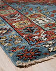 Mira Traditional Red Hand Knotted Wool Rug, a rich red wool rug hand-knotted with an intricate traditional pattern, displayed to showcase its texture and detail.