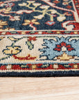 Enchanting Traditional Navy Hand Knotted Wool Rug, showcasing intricate floral motifs and geometric borders in deep navy and contrasting ivory, filling a well-lit living space with timeless elegance.