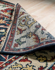 Enchanting Traditional Navy Hand Knotted Wool Rug, navy and cream wool rug with a traditional pattern, seen in a brightly lit room with white walls and modern furniture.