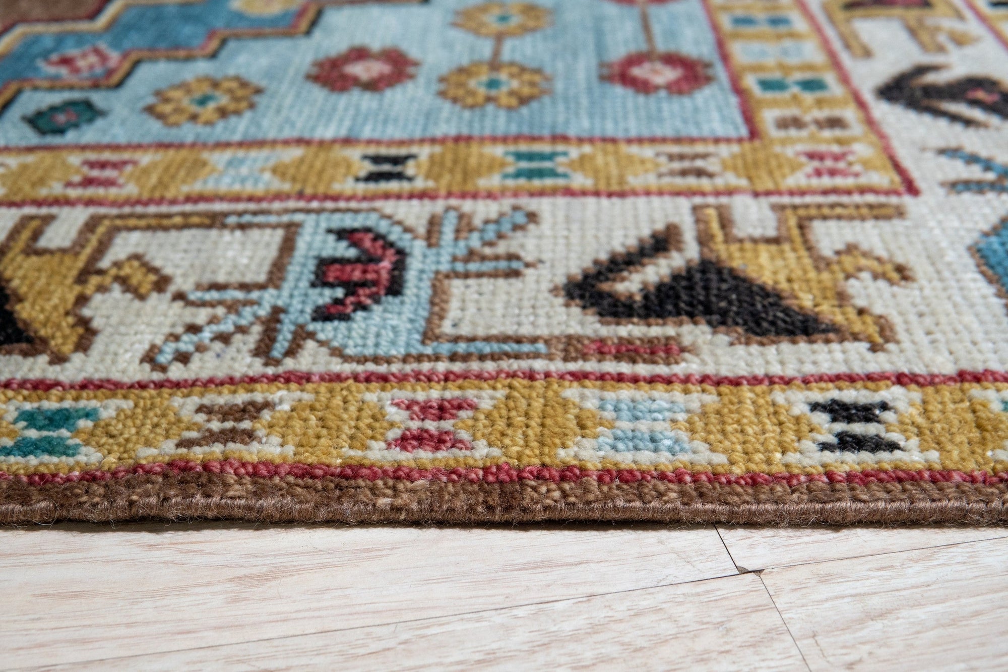 Classic Dazzling Brown Hand Knotted Wool Rug, its intricate hand-knotted construction and warm brown tones radiating sophistication on a light wooden floor.