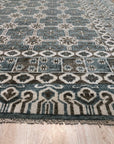 Charming Alluring Gray Hand Knotted Wool Rug, a soft gray wool rug featuring a subtle, textured pattern, laying on a light wood floor, bringing warmth and sophisticated simplicity to the space.