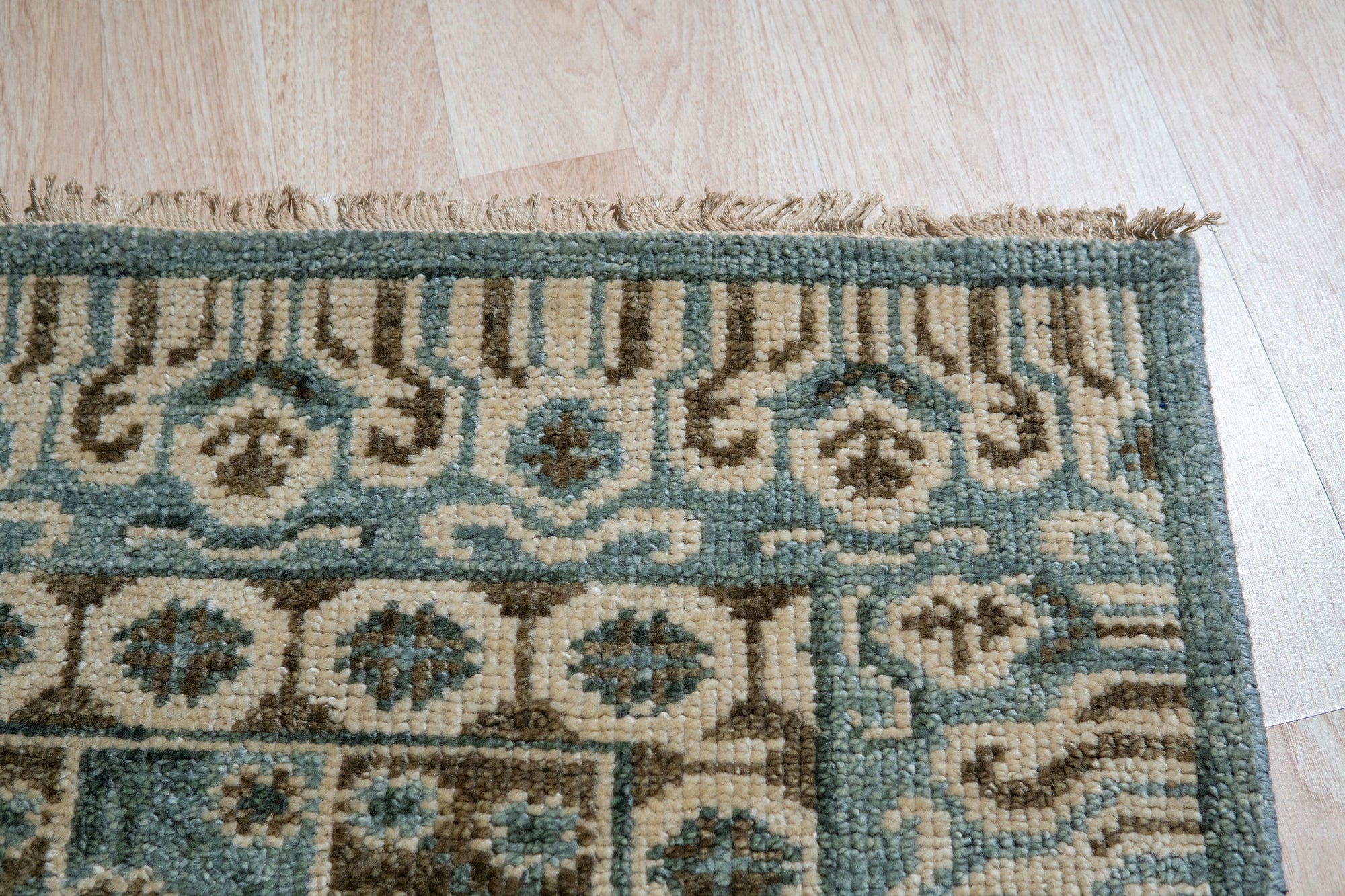 Charming Alluring Gray Hand Knotted Wool Rug, a gray wool rug with a subtle, textured pattern, displayed in a living room setting.