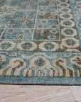 Charming Alluring Gray Hand Knotted Wool Rug displaying a subtle geometric pattern, its soft gray tones creating a sophisticated and calming atmosphere in a well-lit living room setting.