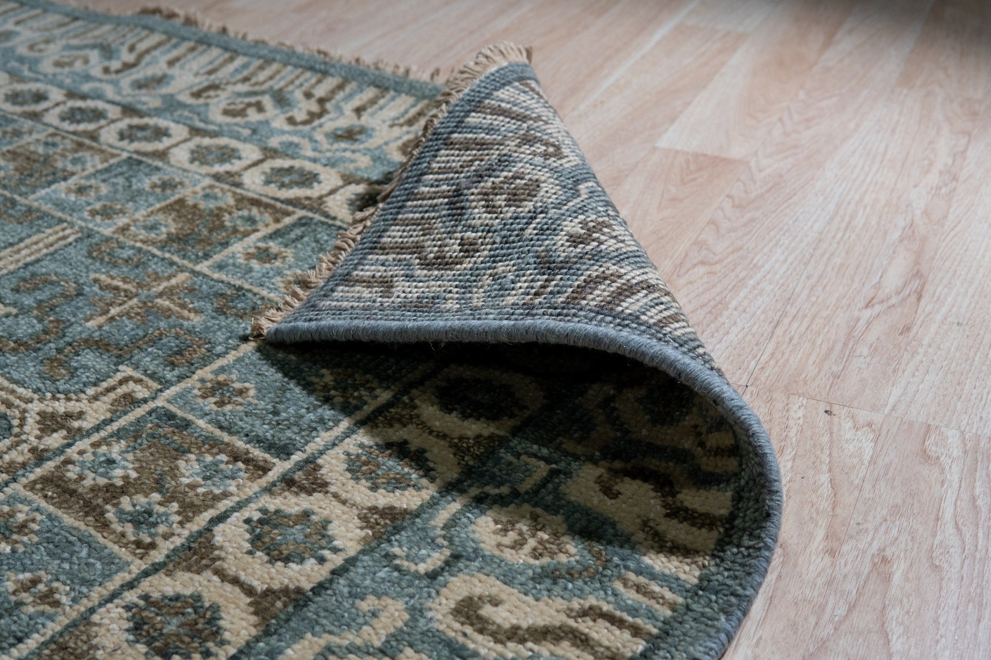 Charming Alluring Gray Hand Knotted Wool Rug, a hand-knotted gray wool rug with subtle textural variations, showcased on a light hardwood floor.