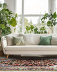 Vibrant Traditional Green Hand Knotted Wool Rug, showcasing intricate patterns and rich green hues, lies gracefully on a light hardwood floor in a brightly lit room.