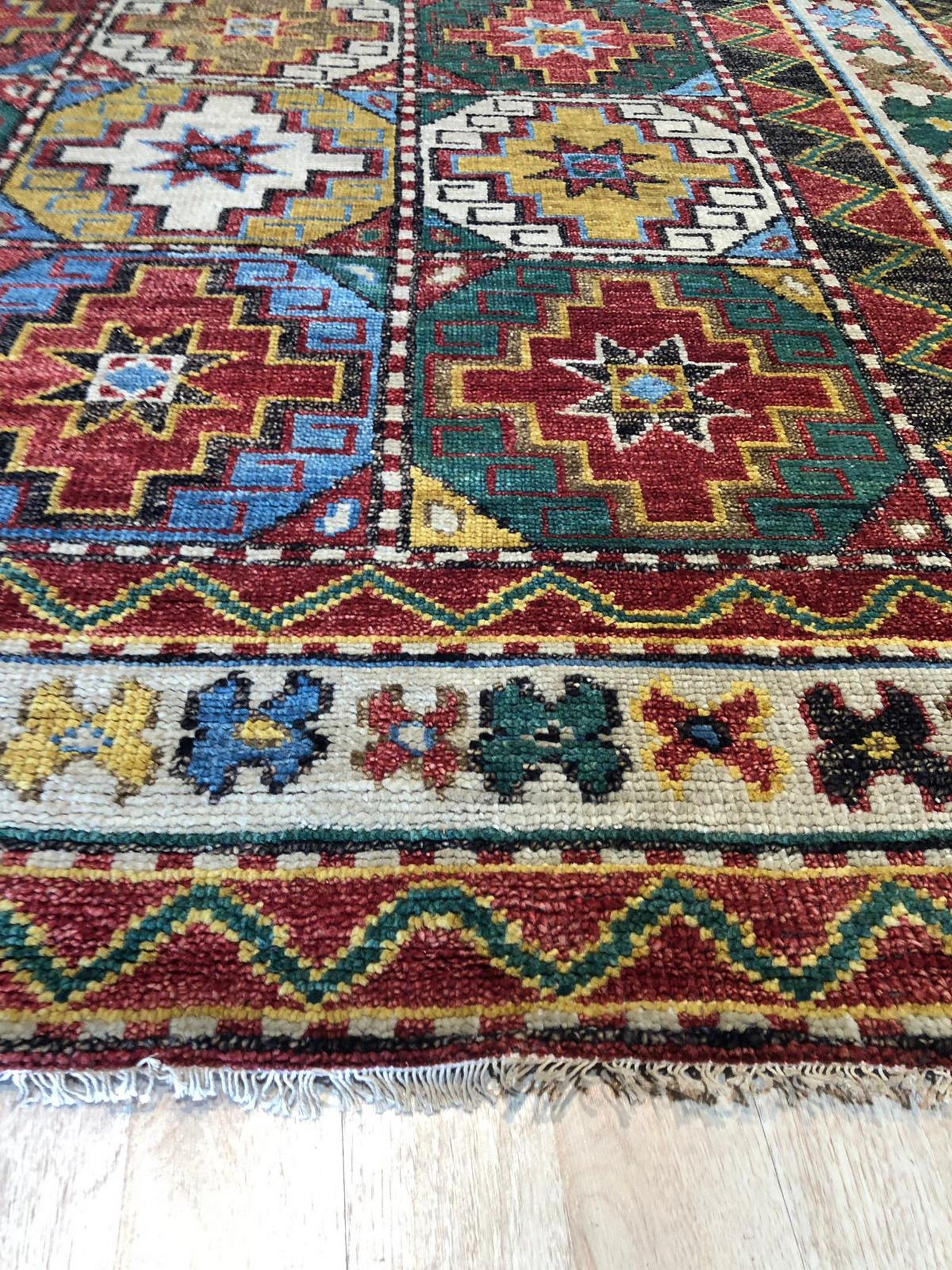 Lydia Kazak Brown Hand Knotted Wool Rug, its intricate geometric patterns in warm browns and creams highlighted in a natural light setting.