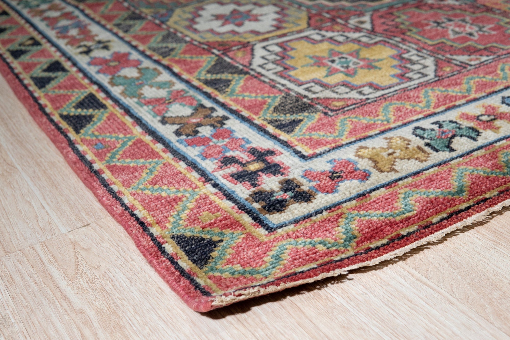 Lydia Kazak Brown Hand Knotted Wool Rug, its warm brown tones and intricate geometric patterns grounding a living space bathed in natural light.