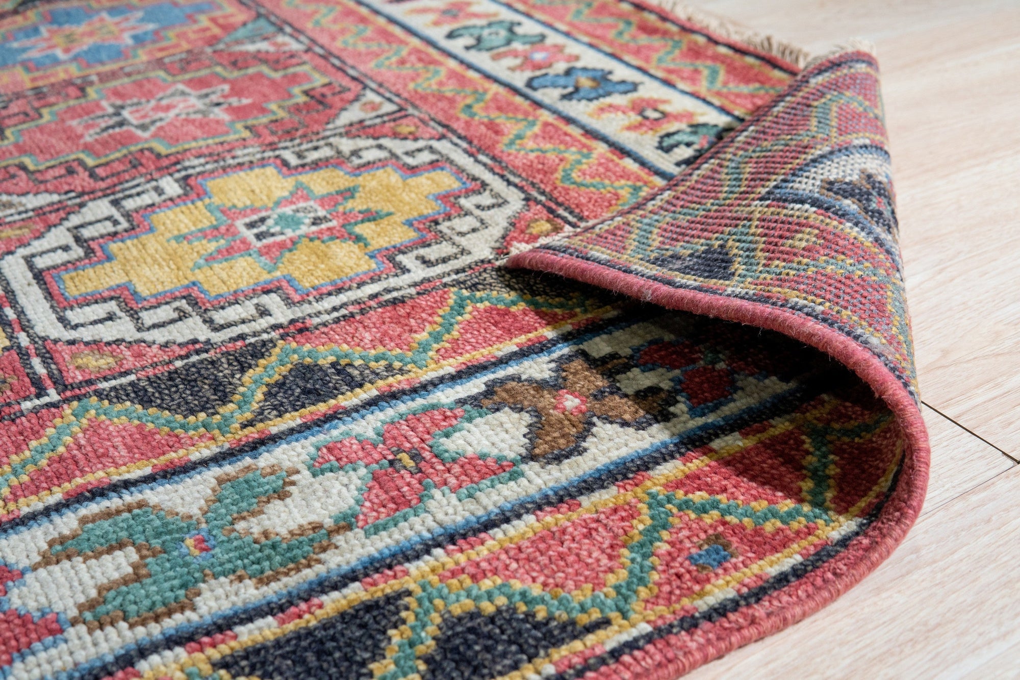 Lydia Kazak Brown Hand Knotted Wool Rug, its intricate geometric pattern in earthy browns and creams grounding a softly lit living room, showcasing its texture and hand-knotted construction.