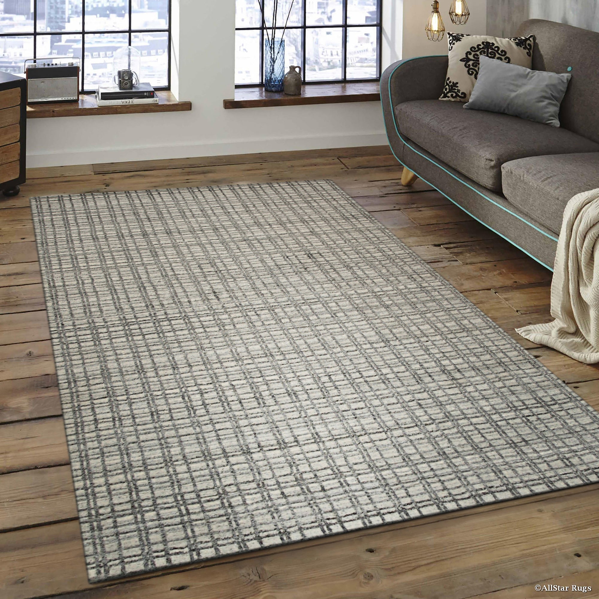 Sumptuous Jade Beige Handmade Wool & Viscose Rug, displaying a subtle sheen and intricate weave, rests elegantly on a dark wood floor, its soft palette complementing a minimalist space.