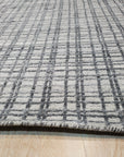 Given the image position is 4, here's the alt text:
 
 Sumptuous Jade Beige Handmade Wool & Viscose Rug, its subtle sheen highlighting intricate design details, rests on a dark wood floor, enhancing the rug's warm tones.