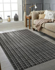 Sumptuous Jade Charcoal Handmade Wool & Viscose Rug, its subtle sheen catching the light in a softly lit room. Textural pile of mixed wool and viscose fibers hints at luxurious comfort underfoot, its jade and charcoal tones creating a sophisticated, calming atmosphere.
