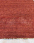 Willow Dazzling Red Handmade Wool Rug, vibrant red wool floor covering with intricate geometric patterns, displayed within a modern living room setting.