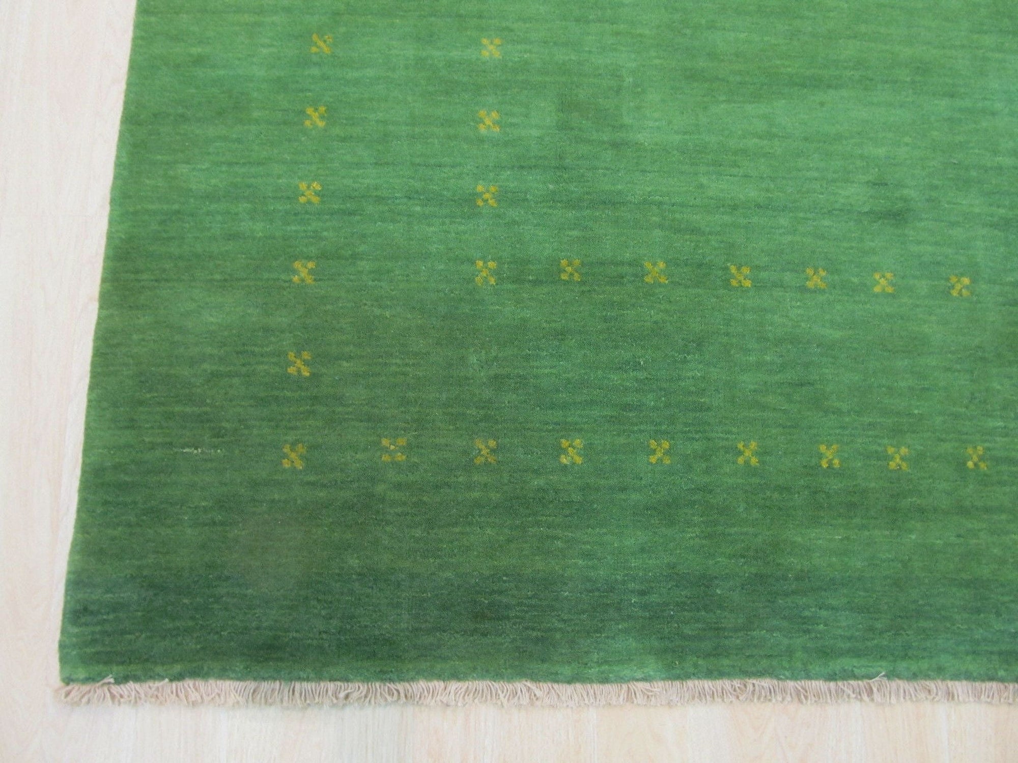 Jasmine Alluring Green Handmade Wool Rug, showcasing its verdant hues and textured wool construction within a bright, modern living space.