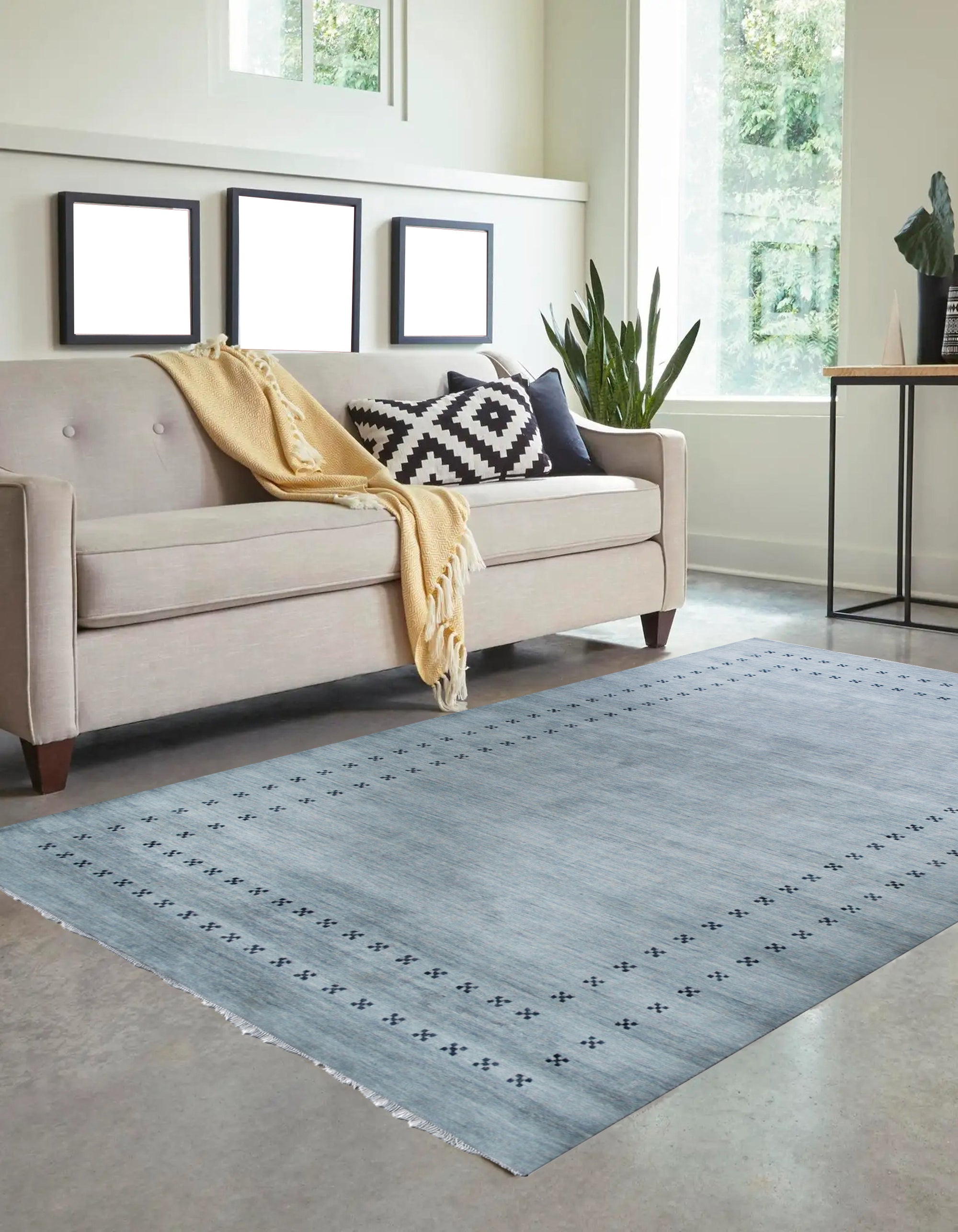 Jasmine Alluring Gray Handmade Wool Rug, invitingly textured and displaying subtle patterns, graces a warmly lit living space; handcrafted wool creates a soft, sophisticated gray floor covering.