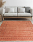 Jasmine Alluring Orange Handmade Wool Rug, radiating warmth with its vibrant orange hues and handcrafted wool texture, displayed in a living room setting.