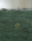 Laine Amara Green Handmade Wool Rug, its textured wool surface a vibrant green, lies on a light wood floor, showcasing its organic, flowing design and handmade construction.