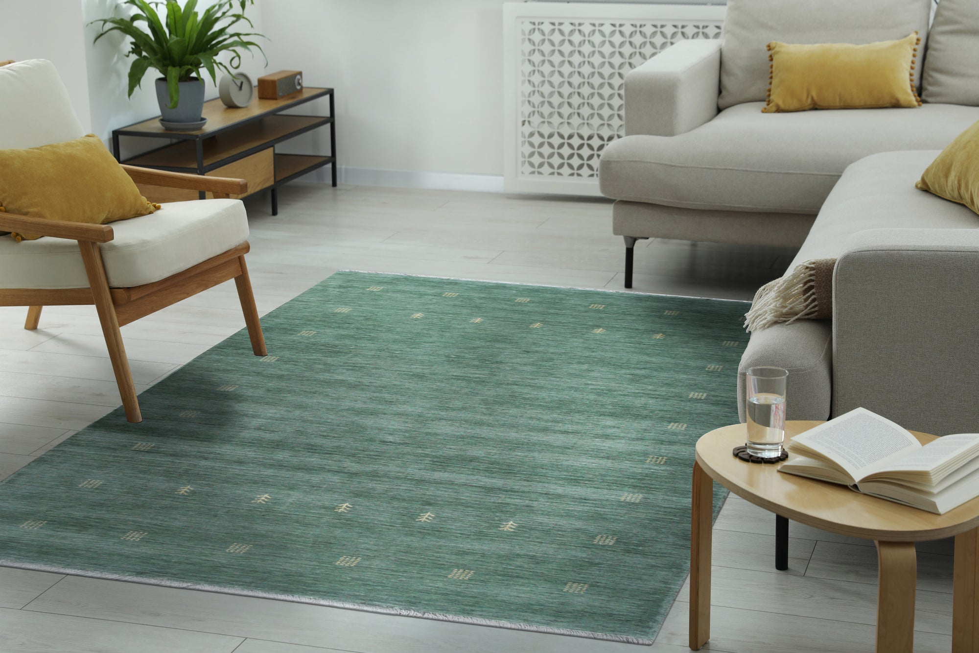 Laine Amara Green Handmade Wool Rug, blending seamlessly into a bright, minimalist living room; soft green hues and subtle textures invite warmth and comfort.
