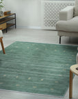Laine Amara Green Handmade Wool Rug, blending seamlessly into a bright, minimalist living room; soft green hues and subtle textures invite warmth and comfort.