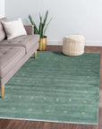 Laine Amara Green Handmade Wool Rug, displaying subtle textures and natural variations across its deep green wool surface, catches the light in a well-lit room setting.