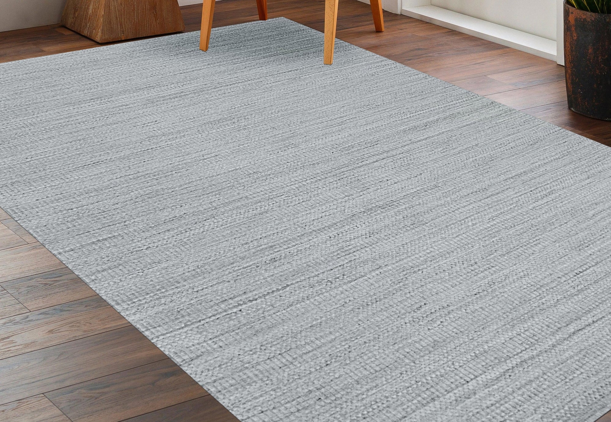 Celia Artistic Beige Handmade Wool Rug, blending soft beige tones in an abstract, flowing design. Warm sunlight illuminates its plush wool fibers, enhancing the rug's artisanal texture and creating a welcoming atmosphere in a bright, modern living space.