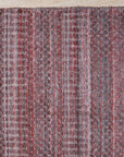 Radiant Elena Red Handmade Wool Rug, a rich crimson and warm ivory wool rug with an intricate, traditional design, lending elegance and vibrant color to a well-lit living room setting.