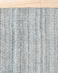 Para Elena Blue Handmade Wool Rug displayed in a brightly lit living room; showcasing its intricate pattern and soft texture against a neutral backdrop.