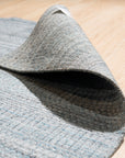 Para Elena Blue Handmade Wool Rug, showcasing a corner section with detailed hand-knotted texture and vibrant blue hues, revealing the rug's intricate design and luxurious wool construction.
