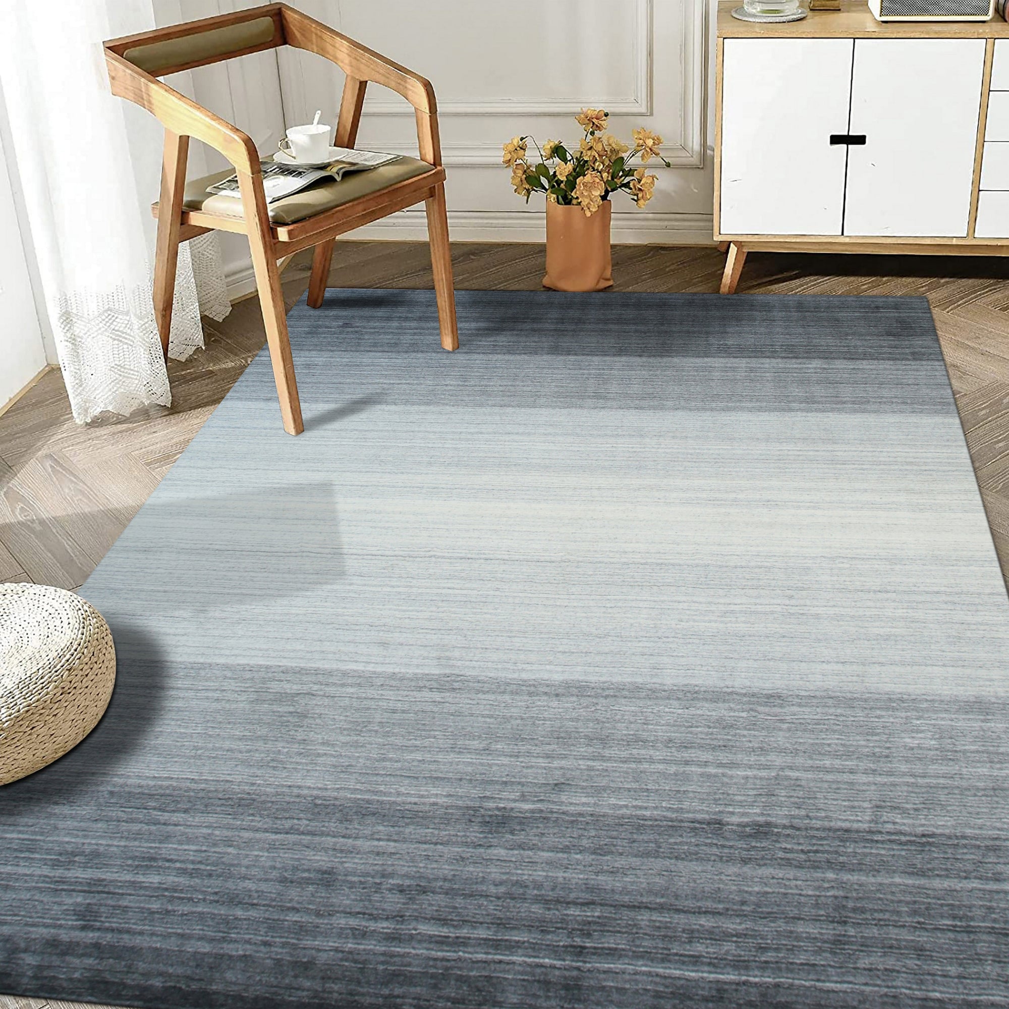 Penelope Nina Charcoal Handmade Wool Rug, charcoal-toned wool rug with subtle texture and handcrafted detail, complementing a modern living space with neutral furniture and warm, natural light.
