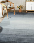 Penelope Nina Charcoal Handmade Wool Rug, charcoal-toned wool rug with subtle texture and handcrafted detail, complementing a modern living space with neutral furniture and warm, natural light.
