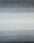 Isolated view of Penelope Nina Charcoal Handmade Wool Rug, showcasing its intricate, textured design and subtle tonal variations in charcoal gray wool.