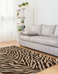 Giselle Xena Green Hand Tufted Wool Rug displayed in a living room setting. The rug, hand-tufted with wool, features shades of green and a modern abstract design, grounding the furniture arrangement.