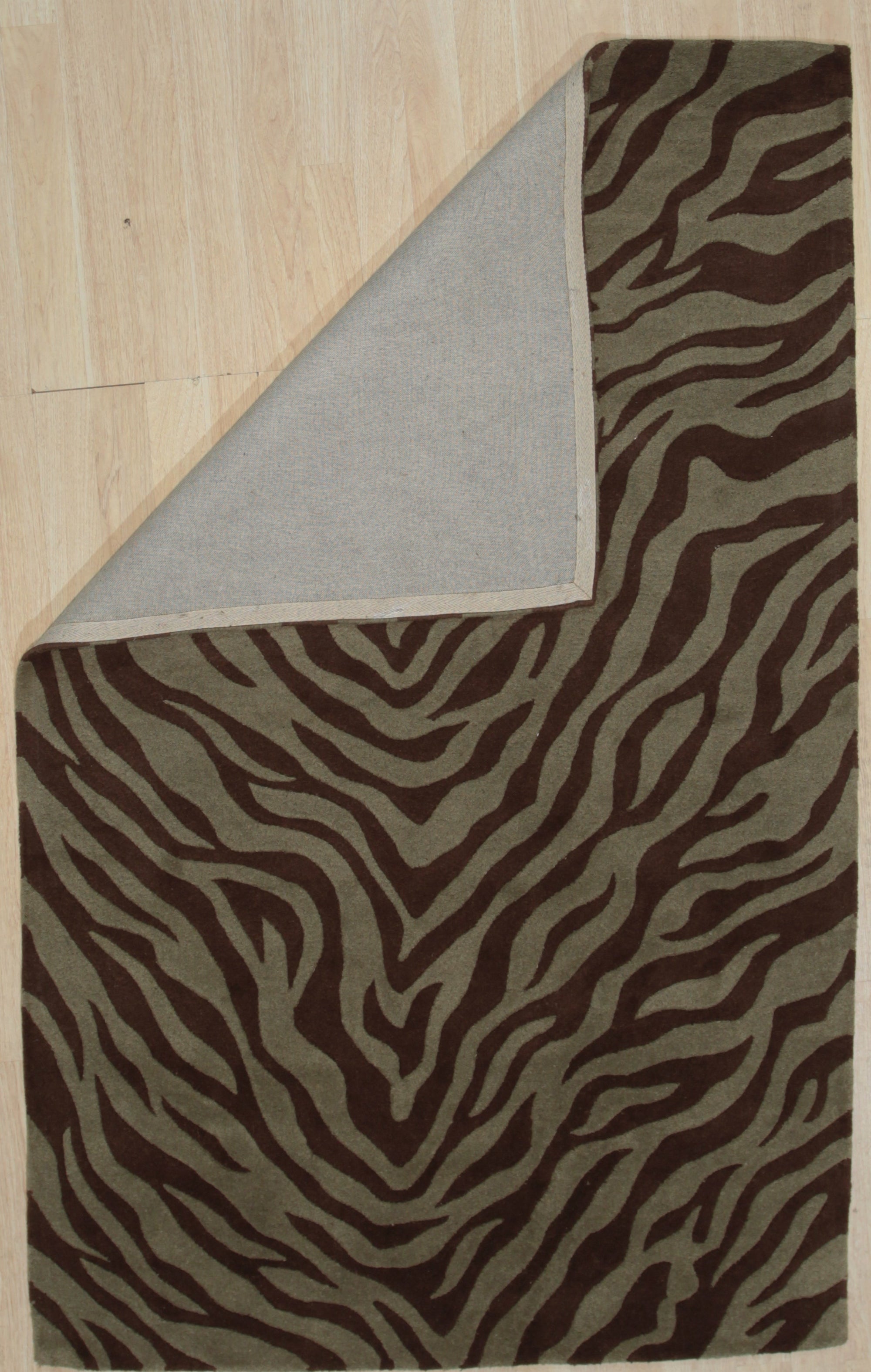 Giselle Xena Green Hand Tufted Wool Rug, a lush green wool rug with a swirling, abstract design, displayed in a brightly lit living room setting with modern furniture.