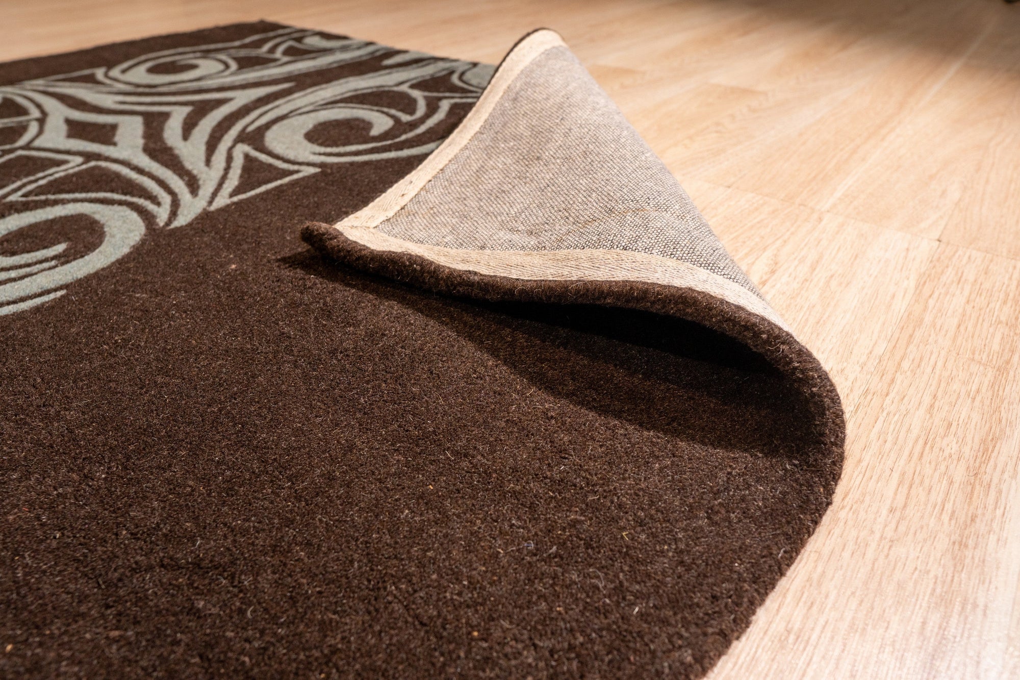 Yara Para Brown Hand Tufted Wool Rug, showcasing textured layers and subtle earth tones in a modern living room setting.