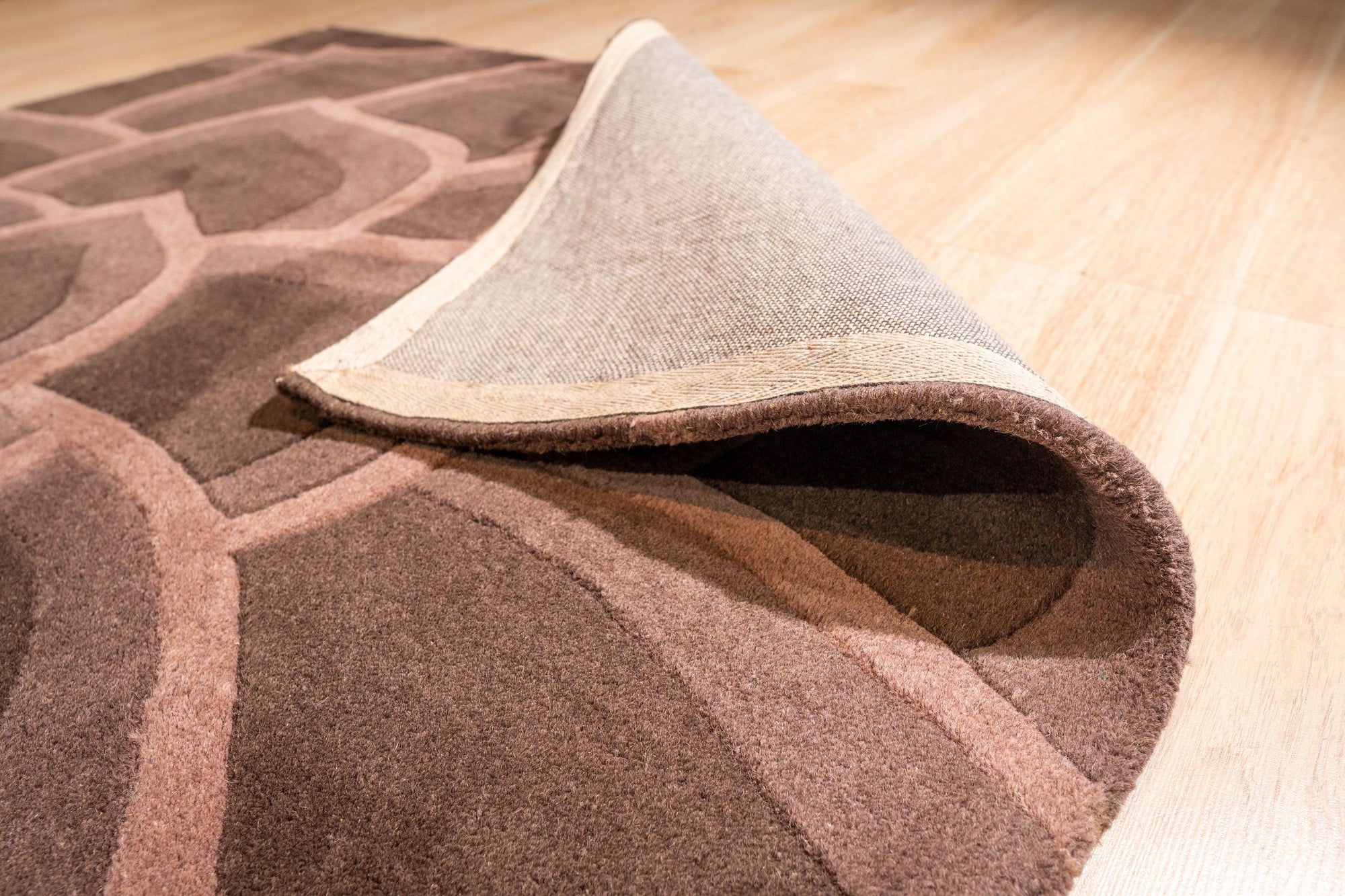 Versatile Kira Brown Hand Tufted Wool Rug, soft brown tones and subtle texture enrich a living space, hand-tufted wool offering cozy comfort underfoot, seen in a home setting.