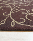 Willow Unique Brown Hand Tufted Wool Rug, showcasing its rich brown hues and textured, hand-tufted construction in a bright, modern living room setting.