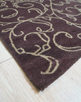 Willow Unique Brown Hand Tufted Wool Rug, its textured brown wool surface displayed in a well-lit interior setting.