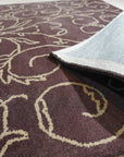 Willow Unique Brown Hand Tufted Wool Rug, its rich brown tones and textured hand-tufted wool visible in a warmly lit living space.
