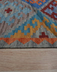 Iris Sophisticated Multicolor Flatweave Wool Rug, a vibrant array of hues woven into a flatweave construction, adds warmth and contemporary style to a modern living room setting.