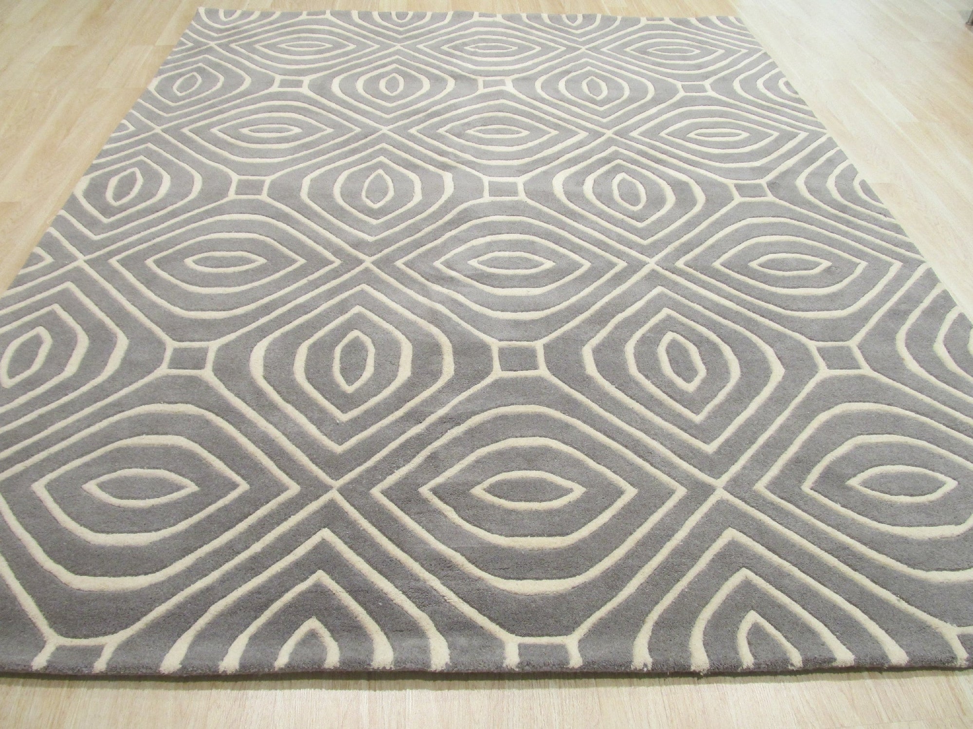 Beautiful Luna Gray Hand Tufted Wool Rug, its subtle grays and hand-tufted texture lending a sophisticated touch to a modern living room setting.