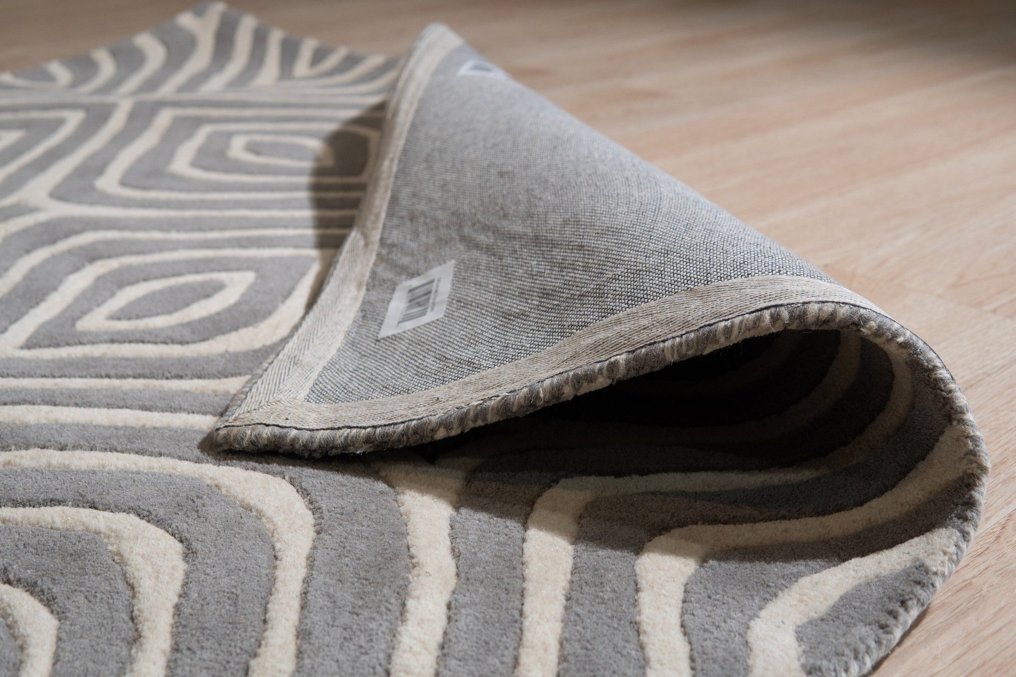 Beautiful Luna Gray Hand Tufted Wool Rug, its soft gray tones and textured hand-tufted construction complementing a modern living room with neutral furniture and natural light.