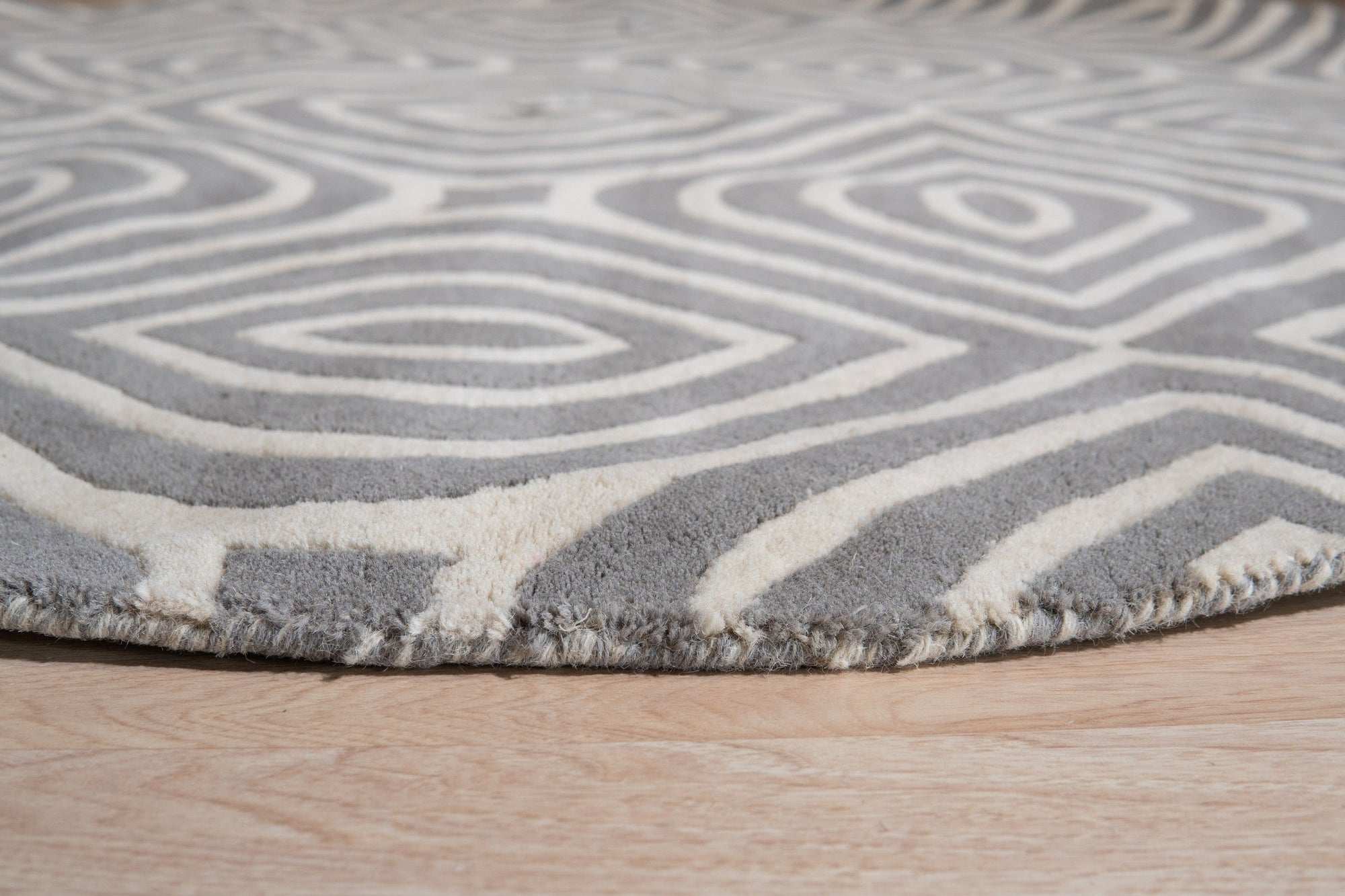 Beautiful Luna Gray Hand Tufted Wool Rug, soft gray tones blend in a modern living room setting, demonstrating the rug's subtle texture and hand-tufted construction under natural light.