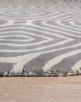 Beautiful Luna Gray Hand Tufted Wool Rug, soft gray tones blend in a modern living room setting, demonstrating the rug's subtle texture and hand-tufted construction under natural light.