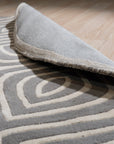 Beautiful Luna Gray Hand Tufted Wool Rug, its plush gray wool surface reflecting soft light in a bright, modern living room.